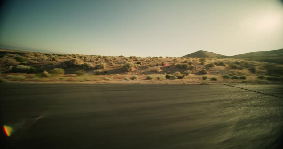 A car races down the desert road