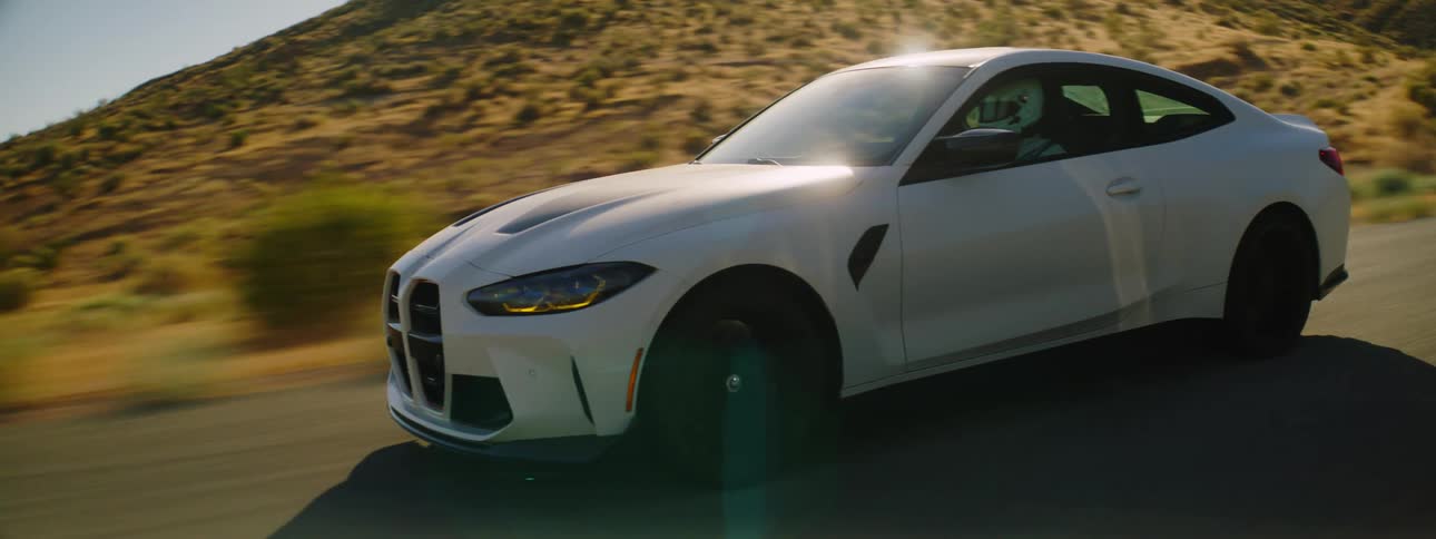A car driving across a desert road
