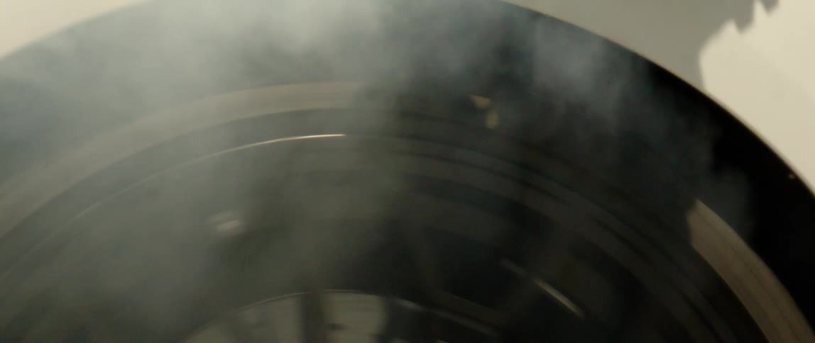 A tire spinning so fast while bringing smokes