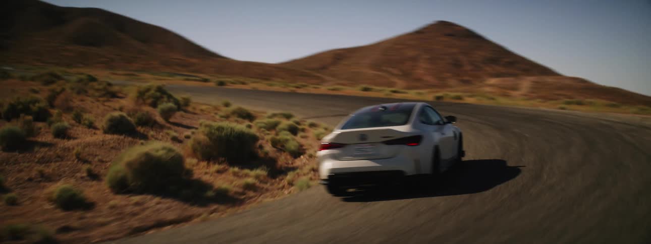 Sports white bmw drifting on a road in a deserted location