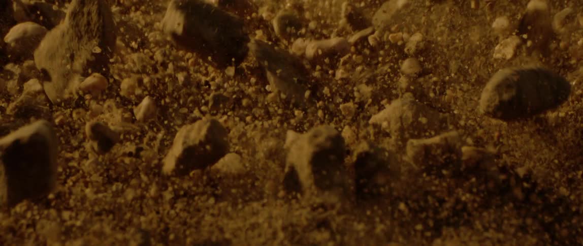 Ground shaking and scattering stones and sand