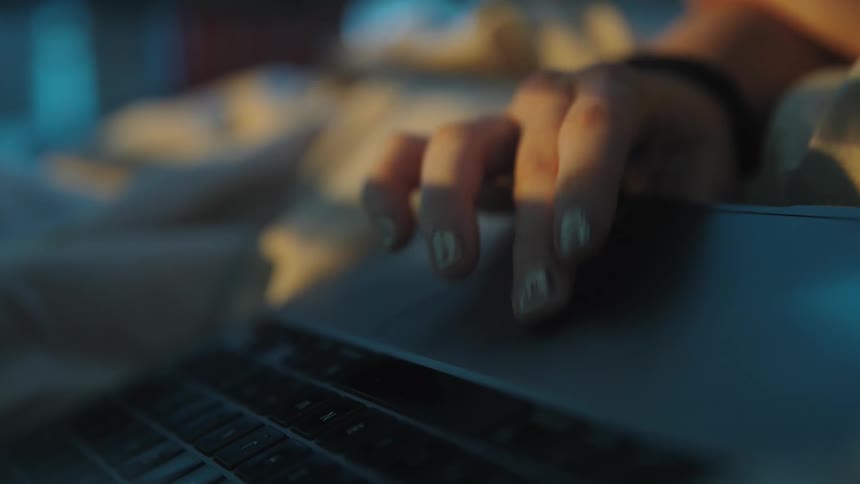 Closeup of a hand swiping a laptops touchpad