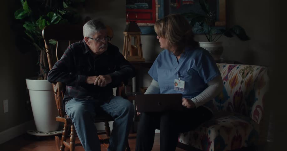A clip of an old man and a nurse having a conversation