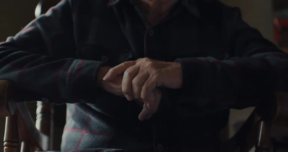 A man old man sits in the chair
