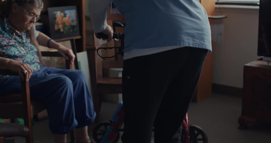 A clip of a nurse aiding an elderly patient with a wheel