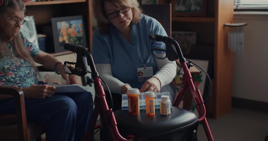 A nurse sorts a patients pills