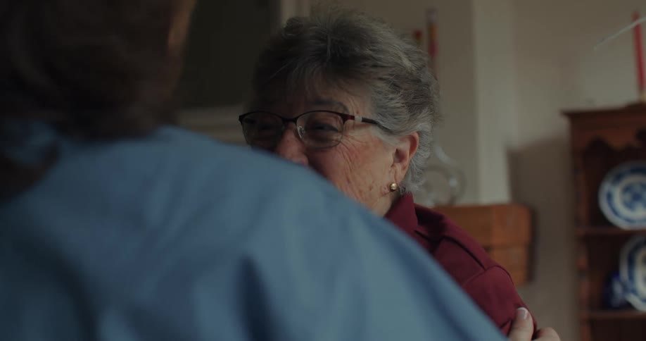 Two women hug in a room