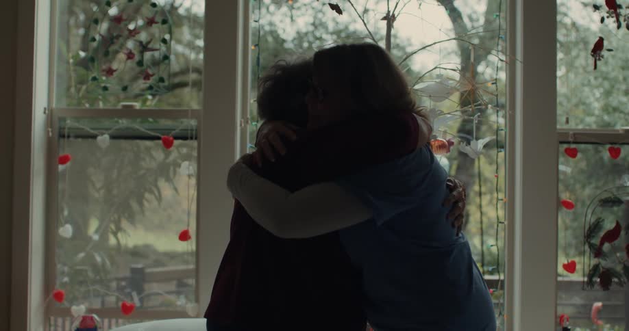 A clip of a nurse and a patient hugging together