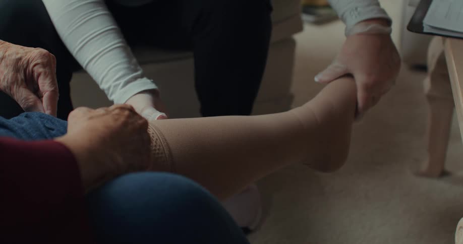 A nurse rubs a patients foot