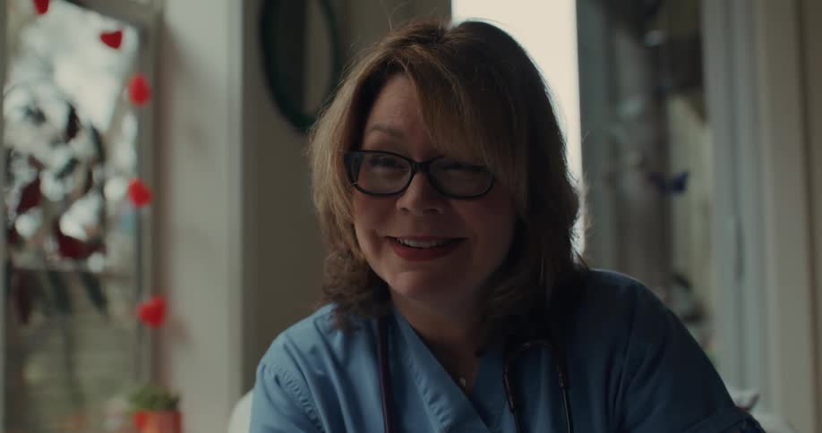 A nurse nods and talks with someone