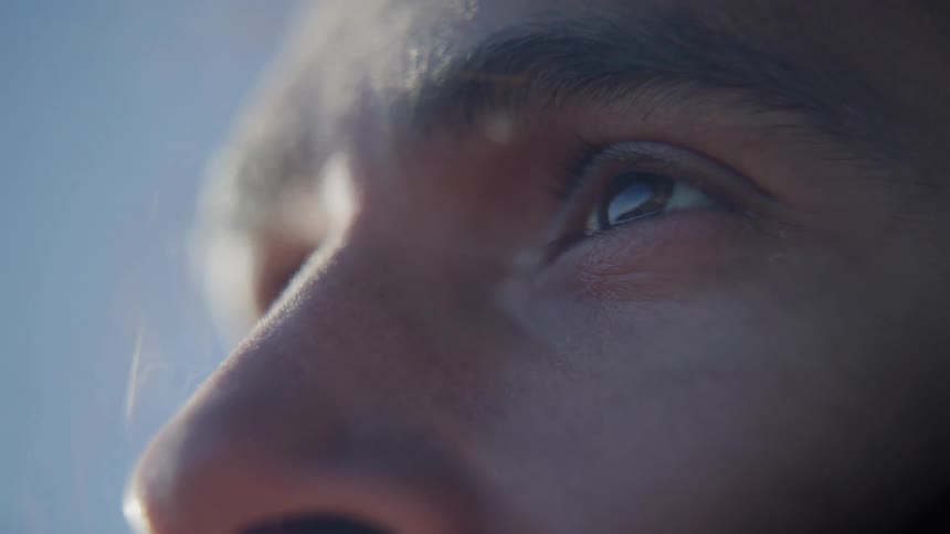 A man stands in the wind looking around