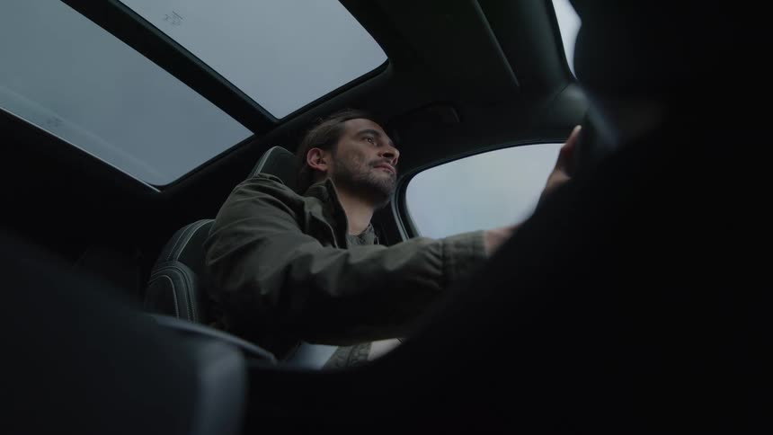 A man is steering his vehicle