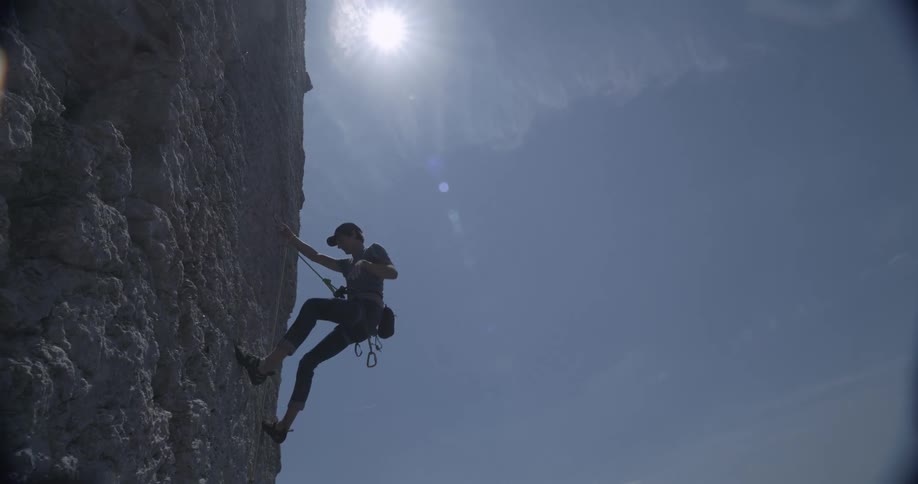 A man climbs a sheer cliff