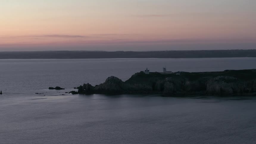 Promontory appears dark due to sunset