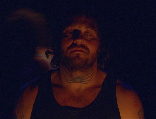 A man is standing outside at night