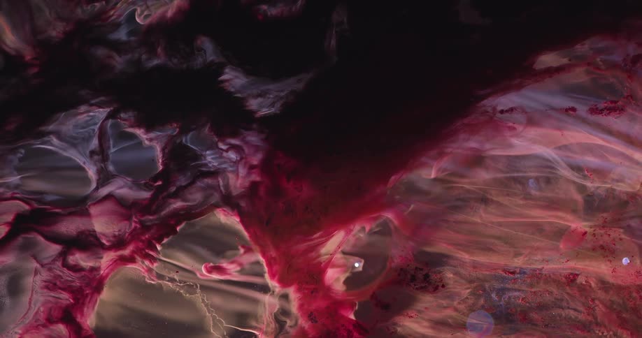 Dense and abstract fluid with reddish and dark coloring and in slow motion