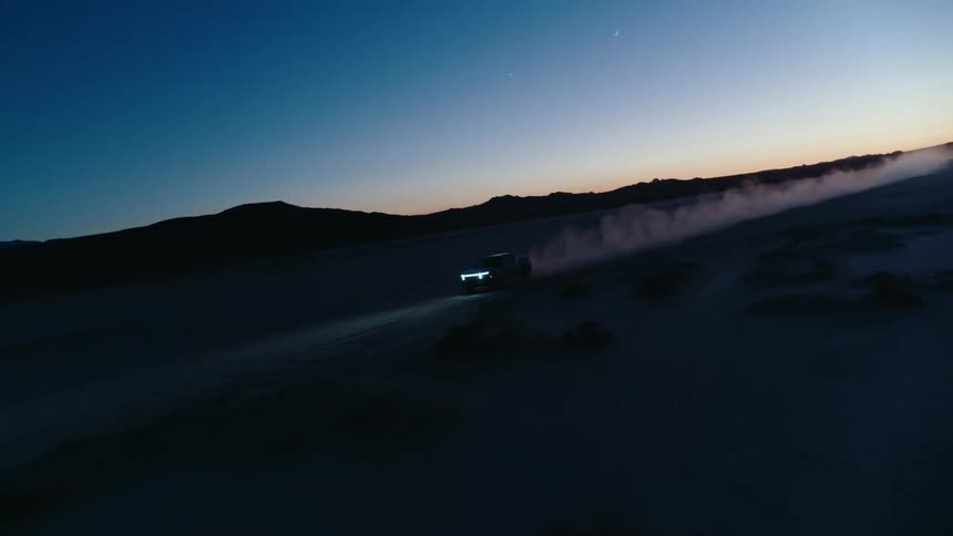 A car drives through a desert