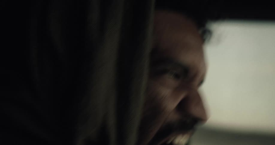 A black man screams while driving a car