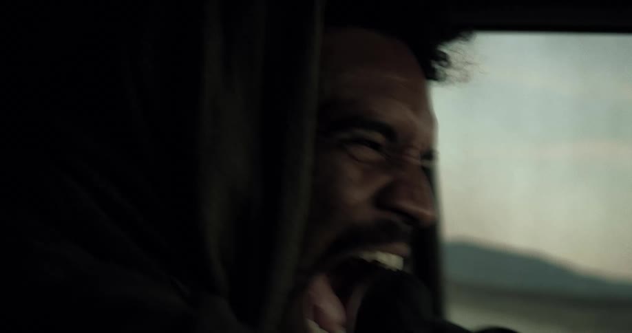 A man screaming while driving a car