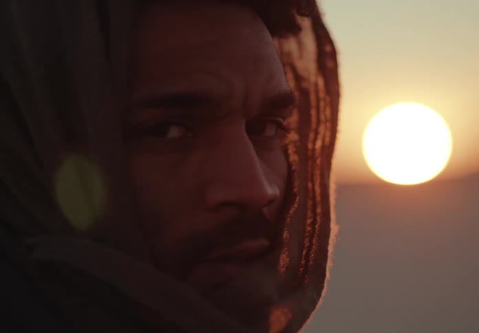 A close up portrait of a man out in a desert