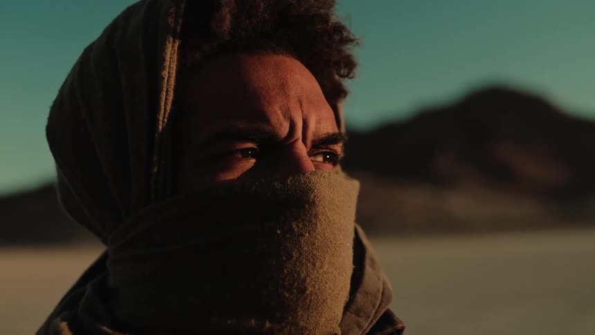A man has a scarf over his face