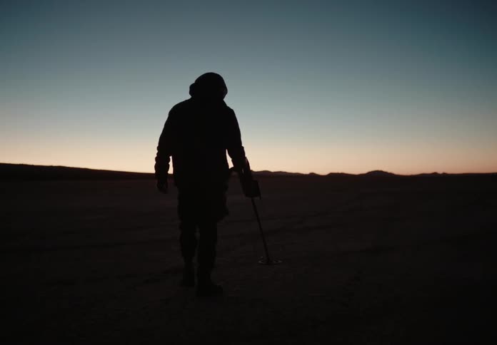 A clip of a man scanning the soil