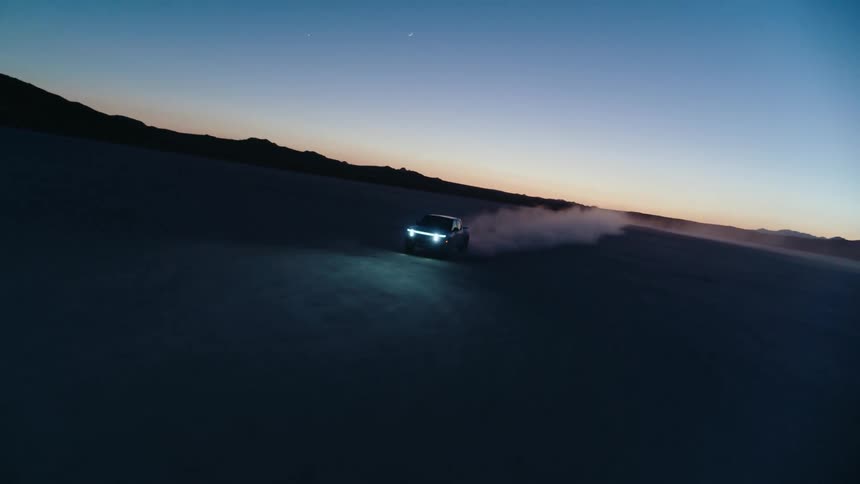 A car drives across a desert
