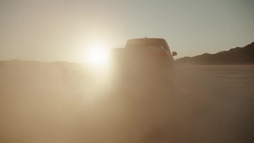 A truck driving through a desert