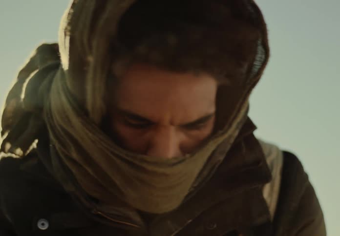 A man is looking down and moving