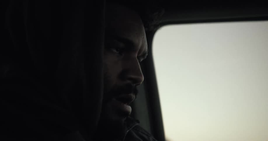A black man drives a vehicle
