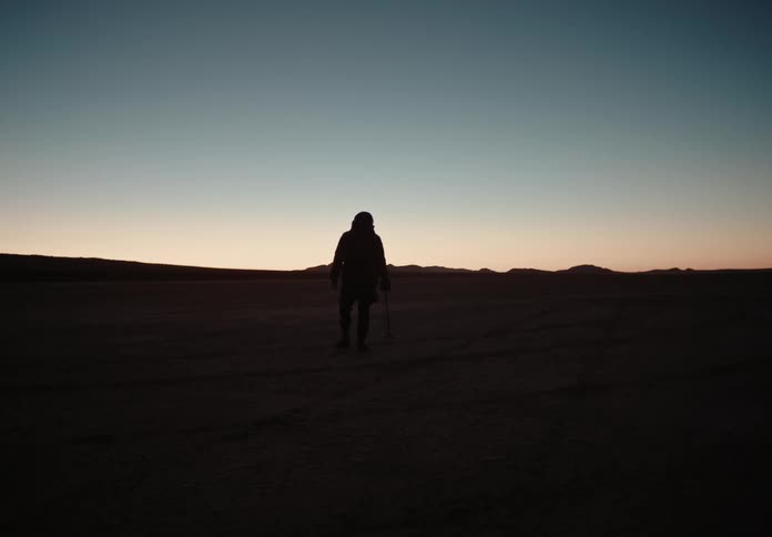 A person walking outdoors at dusk