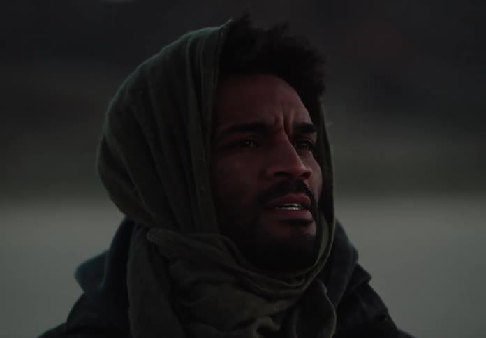 A man out in the desert looking into the distance
