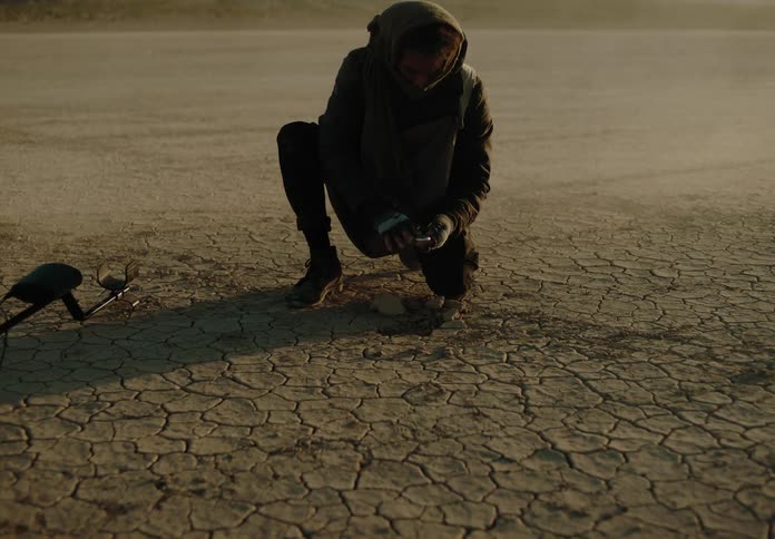 A man find an object in the desert while metal detecting