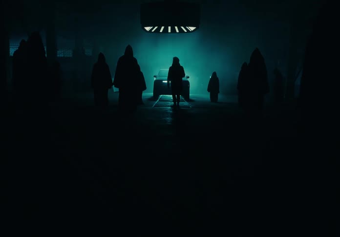 A night clip of people standing beside a car