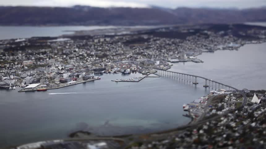 Aerial of a bridge crossing a river in a harbor city