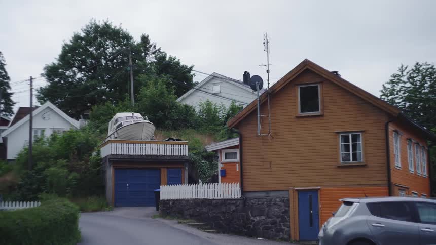 A house with a boat on top of its garage