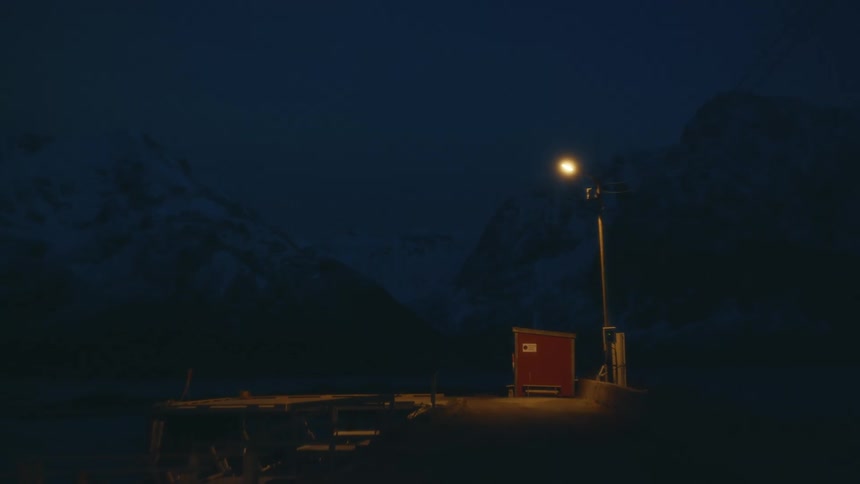A small shack is by the mountain
