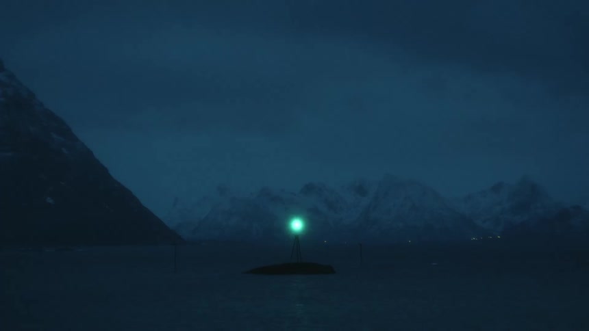 A lighthouse on an island blinks light