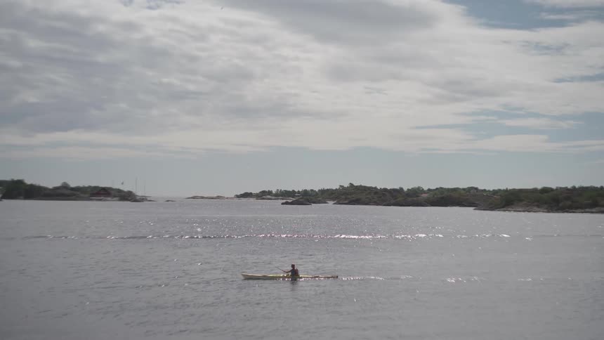 Someone crossing a river in a canoe