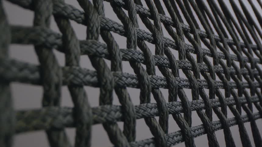 Ropes intertwined sideways and downwards forming small squares in places where there is no rope