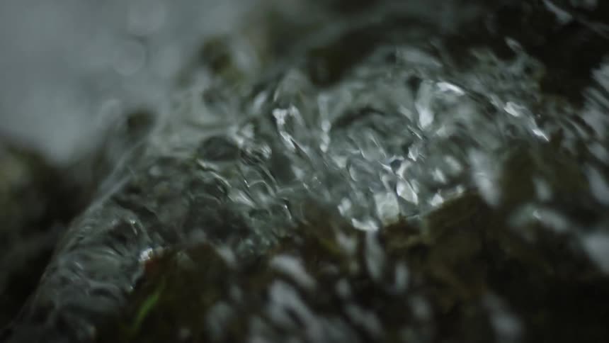 Stream water flowing over a rock