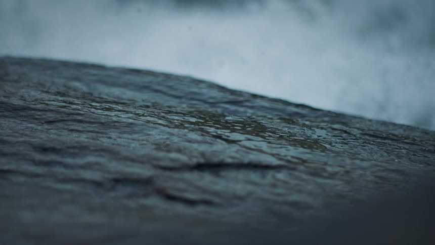 Water from a turbulent river splash over the rocks