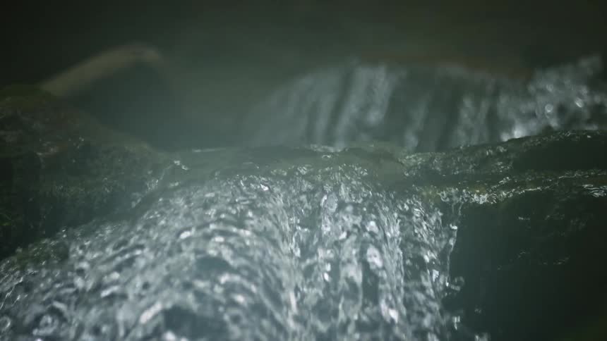 The stream runs over the rocks