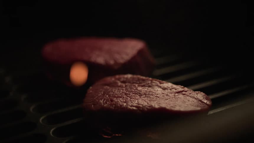 Steaks are cooking on the grill