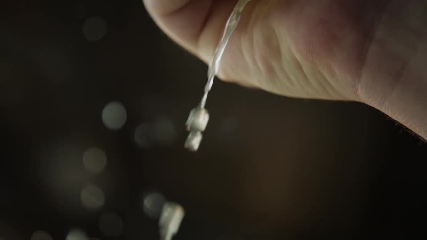 Hand squeezing lemon juice in slow motion