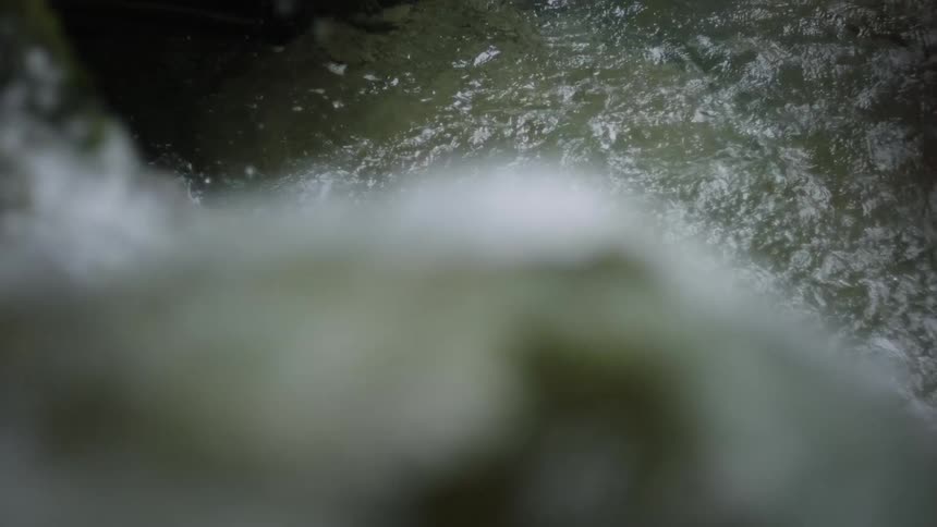 Water flows down short falls into stream