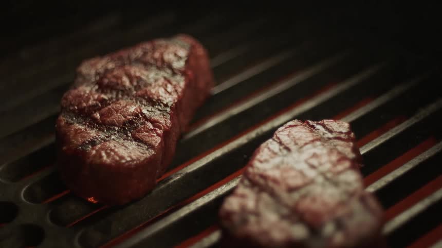 Steak placed on a hot grill