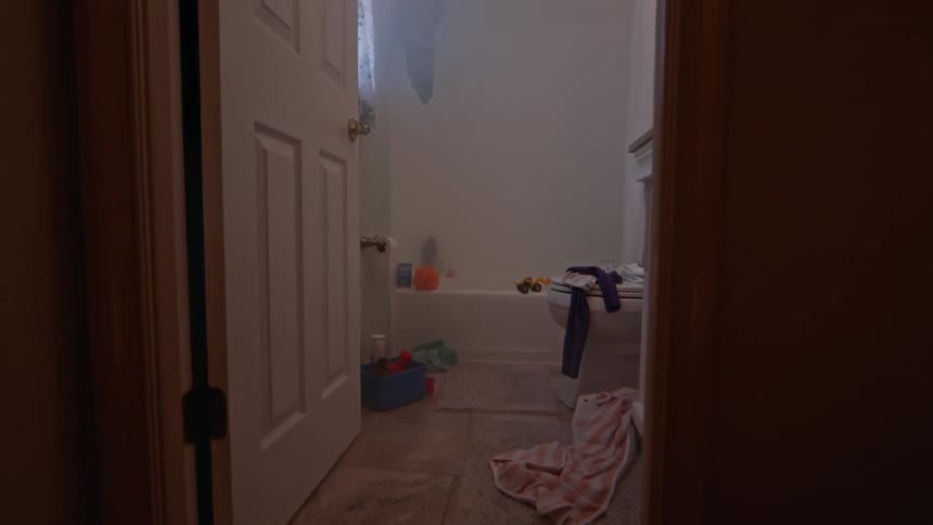 Laundry scattered all over a bathroom