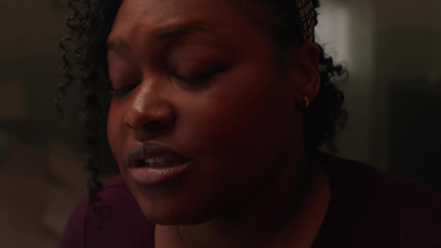 A black woman looking apprehensive