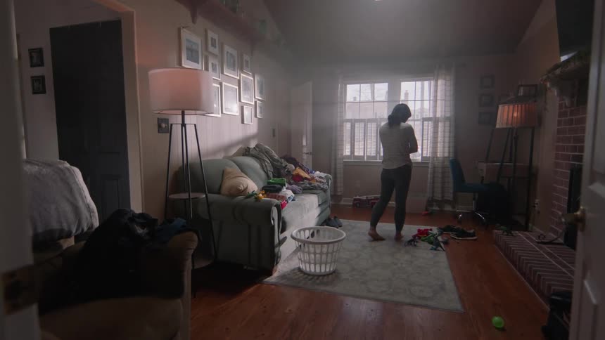 A woman paces around looking worried or depressed